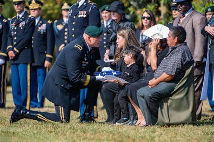Does the oldest son get the flag at a military funeral?