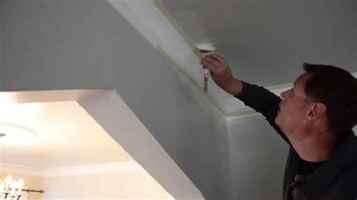 Should I caulk between crown molding and ceiling?